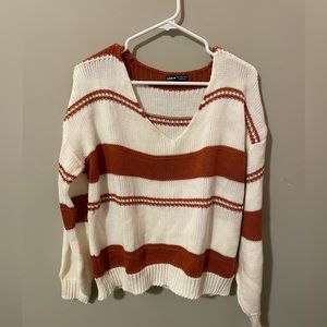 White and burnt orange striped sweater